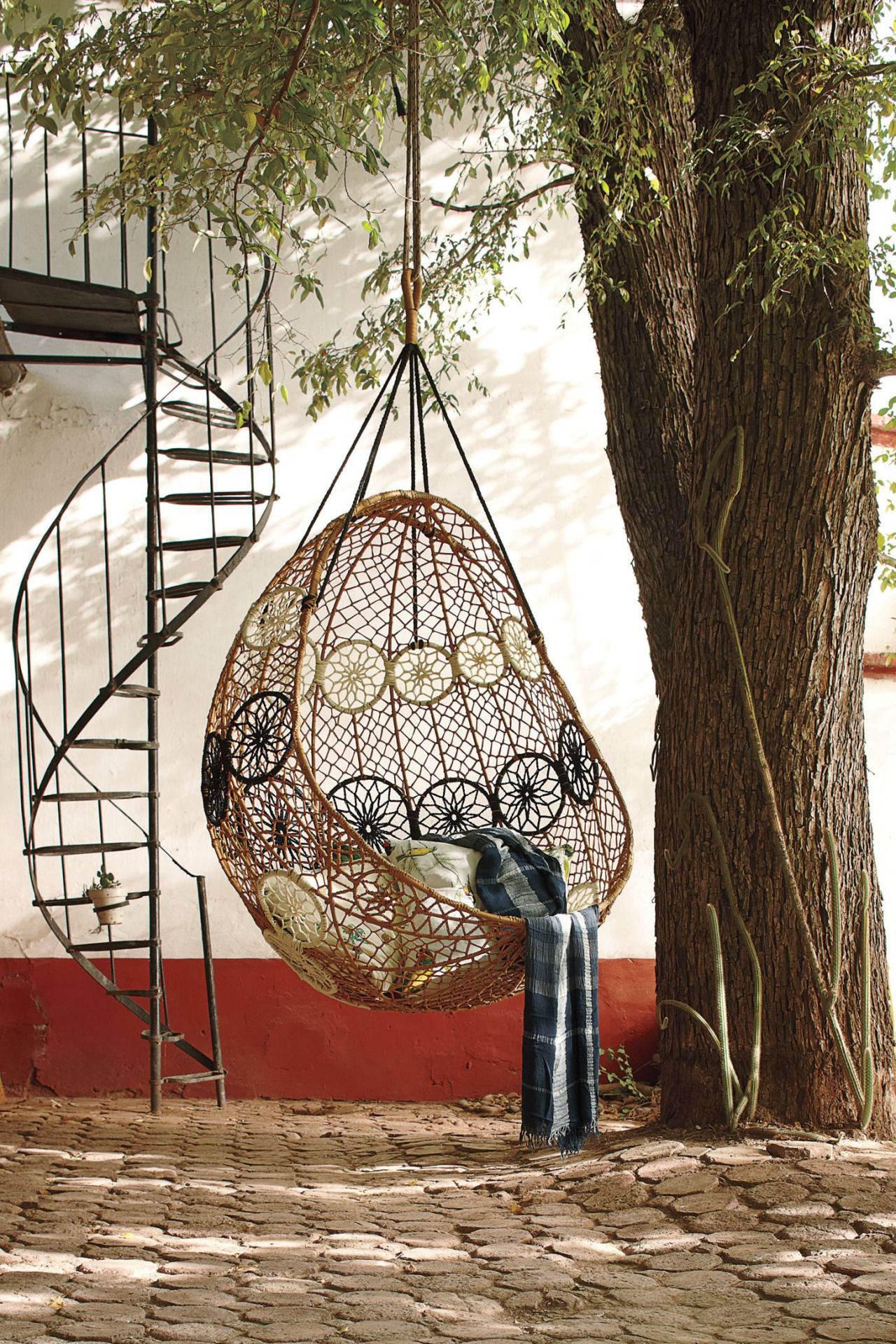Cozy rattan armchair in the form of a swing