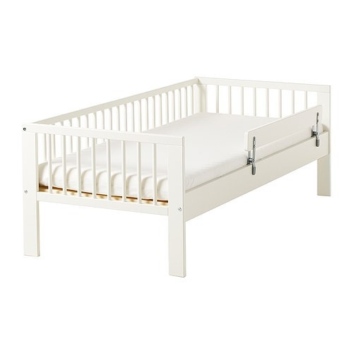 Children's bed with a protective side